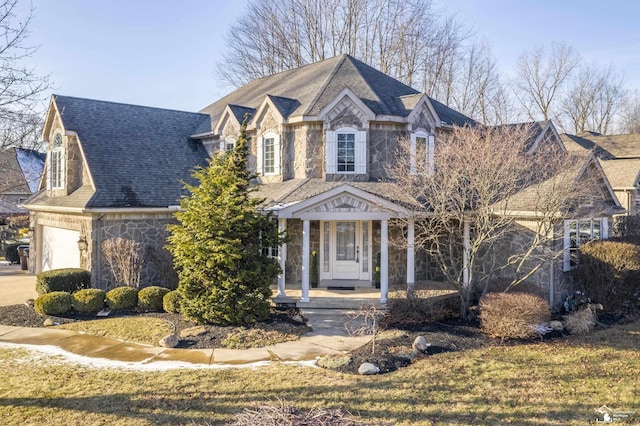 view of front of house featuring a garage and a front lawn