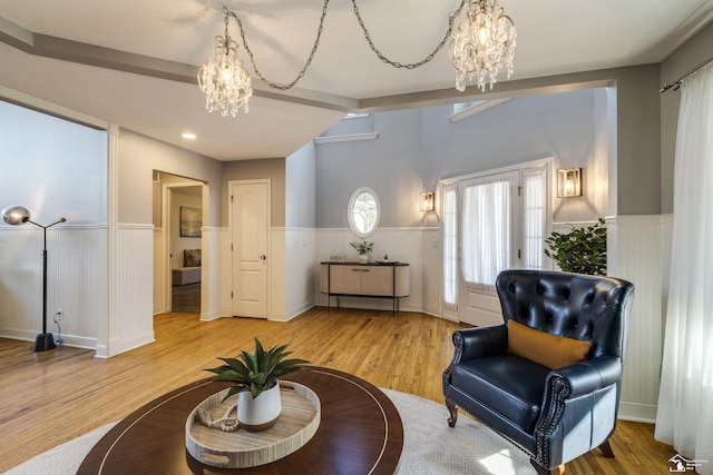 sitting room with an inviting chandelier and light hardwood / wood-style flooring