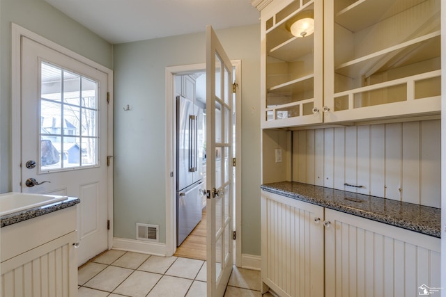 interior space with sink and light tile patterned floors