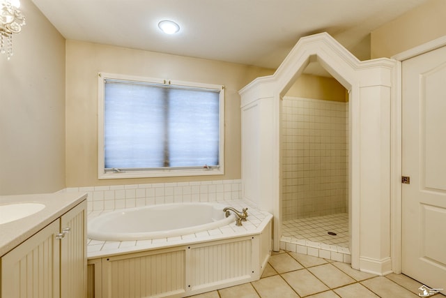 bathroom with tile patterned flooring, vanity, and independent shower and bath