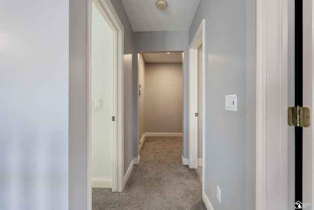 hall with light colored carpet