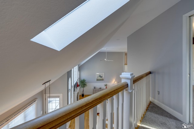 hall featuring lofted ceiling and carpet floors