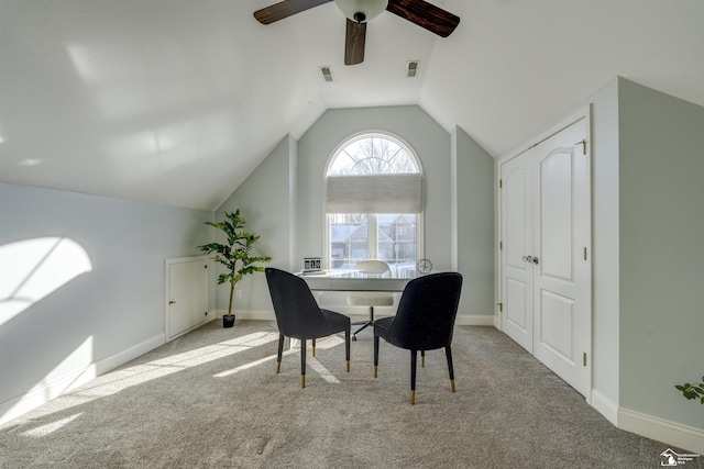 dining room featuring lofted ceiling, light carpet, and ceiling fan