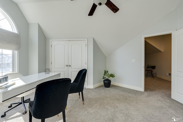 office area featuring lofted ceiling, light carpet, and ceiling fan