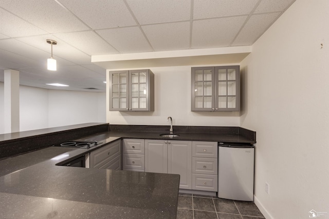 kitchen featuring dishwashing machine, gray cabinets, electric stovetop, and a drop ceiling