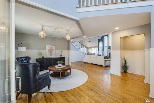 sitting room with a notable chandelier and light hardwood / wood-style floors