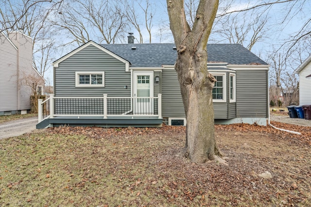 rear view of property with a wooden deck