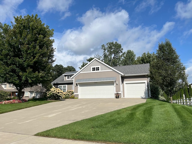 view of front of house with a garage and a front lawn