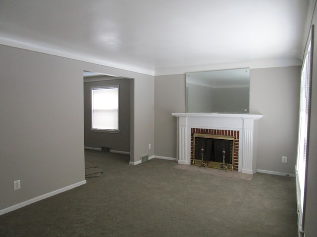 unfurnished living room featuring dark carpet and a fireplace