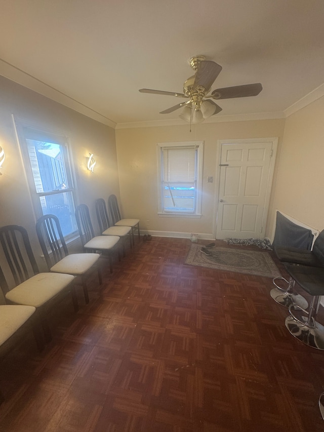 entryway with dark parquet flooring, ornamental molding, and ceiling fan