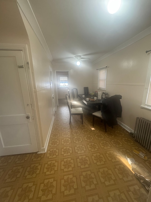 dining space with ceiling fan, ornamental molding, and radiator