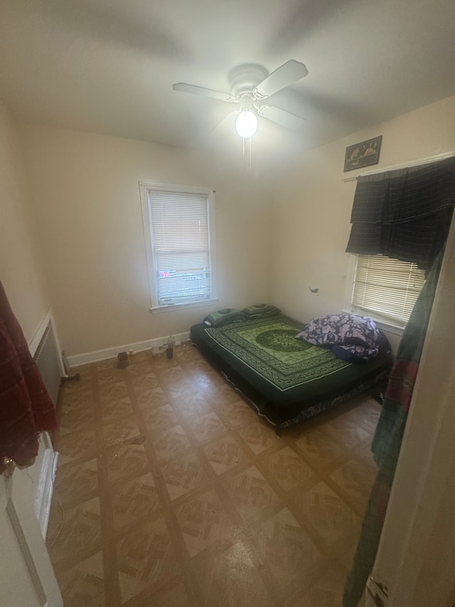 bedroom with parquet flooring and ceiling fan