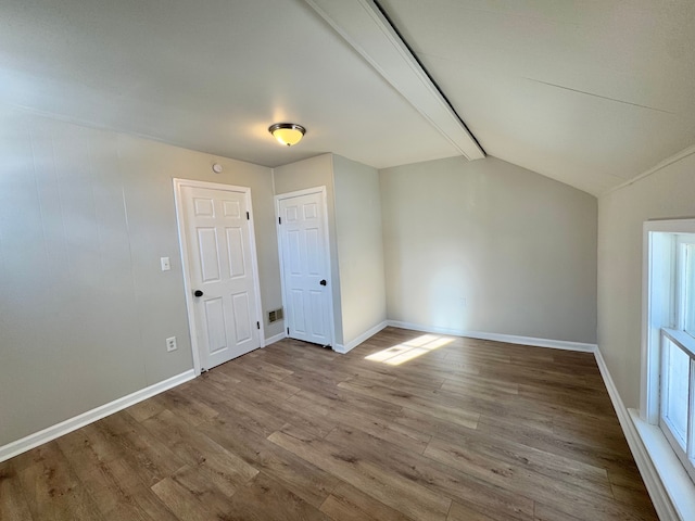 bonus room featuring vaulted ceiling and light hardwood / wood-style floors