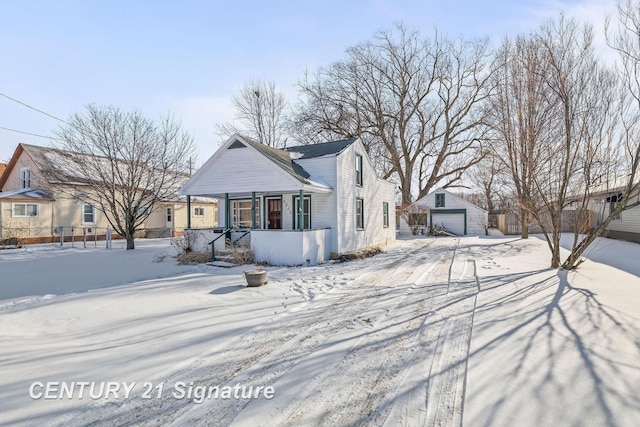 view of front of property featuring a garage and an outdoor structure