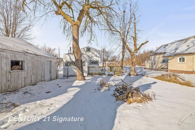 yard covered in snow featuring a deck