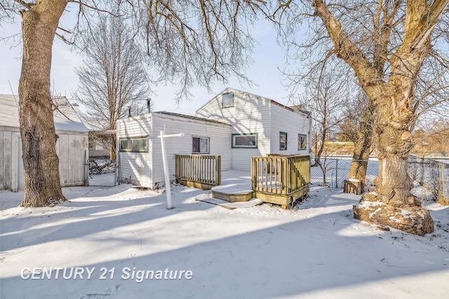 snow covered property featuring a wooden deck