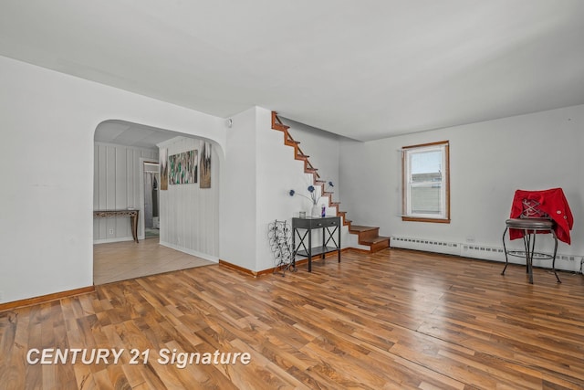 empty room with a baseboard radiator and wood-type flooring