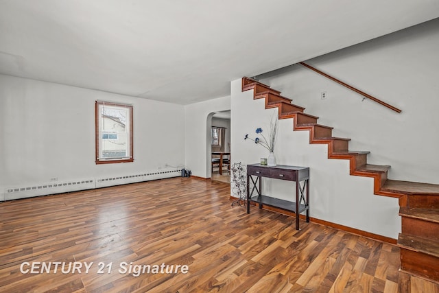 interior space featuring a baseboard heating unit and hardwood / wood-style flooring