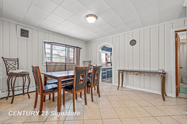 dining room featuring ornamental molding, light tile patterned flooring, and baseboard heating