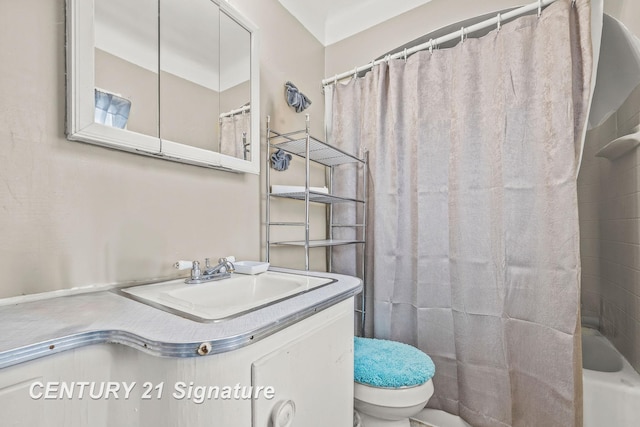 full bathroom featuring shower / tub combo with curtain, sink, and toilet