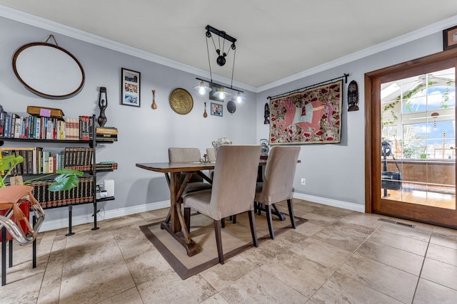 dining space featuring crown molding