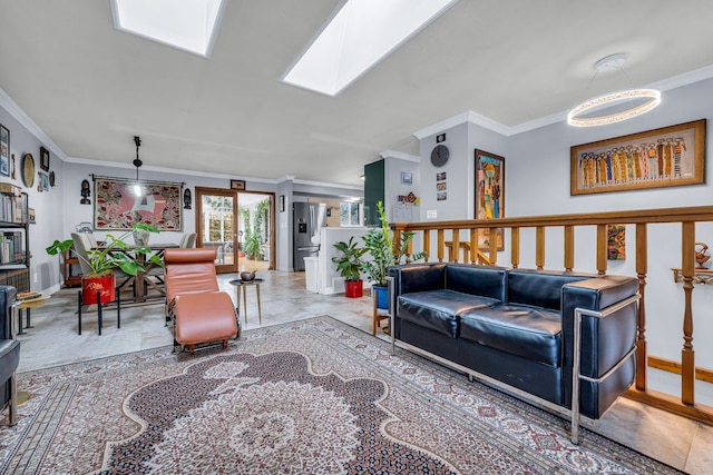 living room with a skylight and ornamental molding