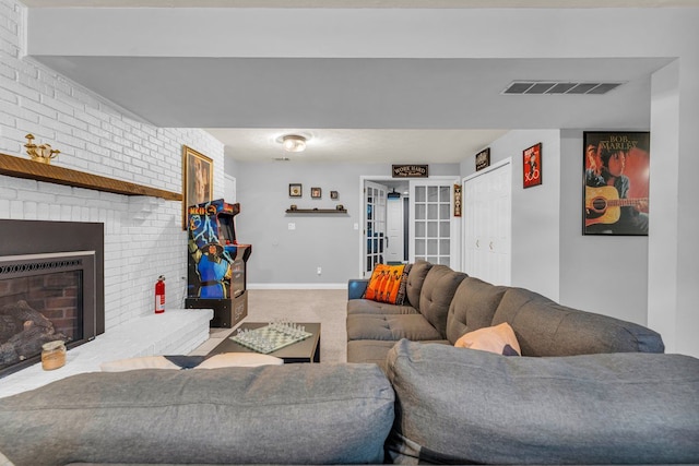 living room with carpet and a fireplace