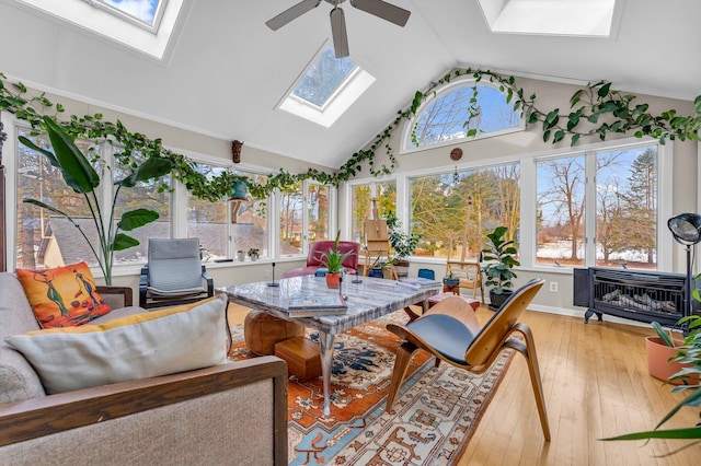 sunroom / solarium with lofted ceiling with skylight and ceiling fan