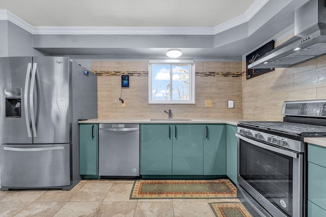 kitchen featuring tasteful backsplash, sink, ornamental molding, stainless steel appliances, and wall chimney exhaust hood