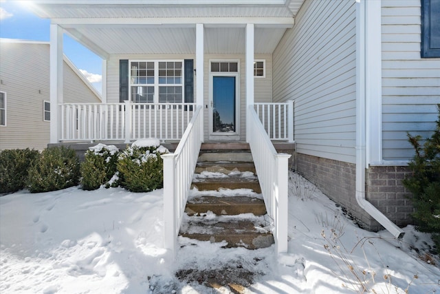 view of snow covered property entrance