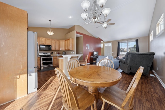 dining room with high vaulted ceiling, dark hardwood / wood-style floors, and ceiling fan