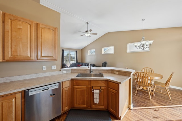 kitchen with sink, decorative light fixtures, dishwasher, kitchen peninsula, and hardwood / wood-style floors