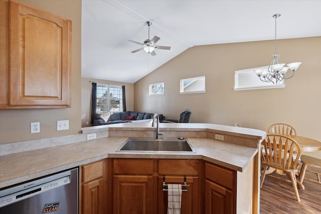 kitchen featuring ceiling fan with notable chandelier, sink, stainless steel dishwasher, kitchen peninsula, and light wood-type flooring