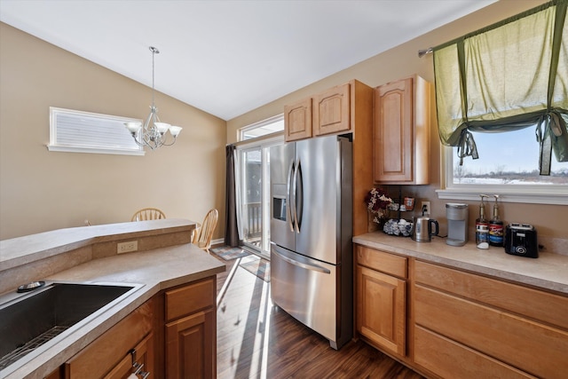 kitchen with decorative light fixtures, a wealth of natural light, dark hardwood / wood-style flooring, and stainless steel fridge with ice dispenser