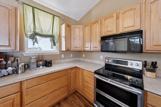 kitchen featuring lofted ceiling, light brown cabinets, dark hardwood / wood-style floors, and range with two ovens