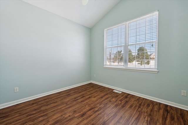 unfurnished room featuring lofted ceiling and dark hardwood / wood-style flooring