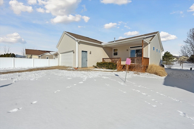 view of front of house with a garage and a deck