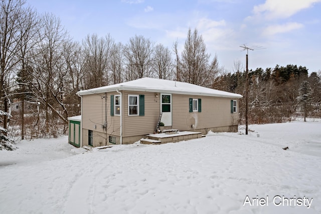 view of snow covered rear of property