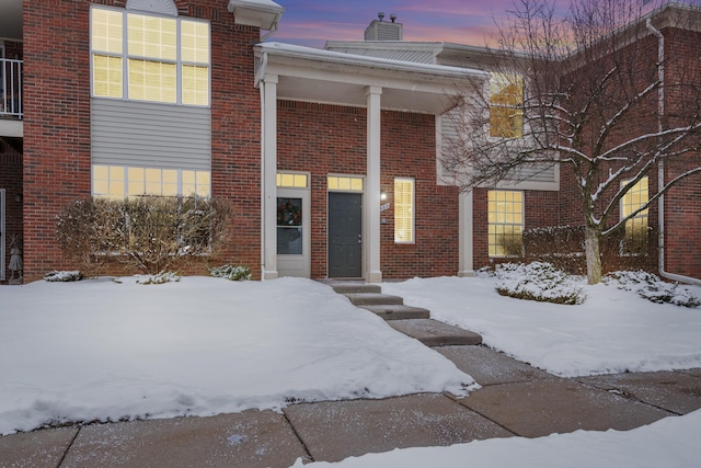 view of snow covered property entrance