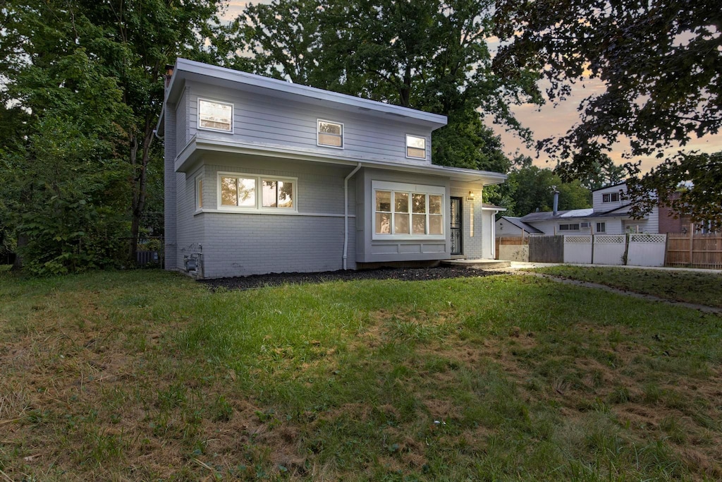 back house at dusk with a yard