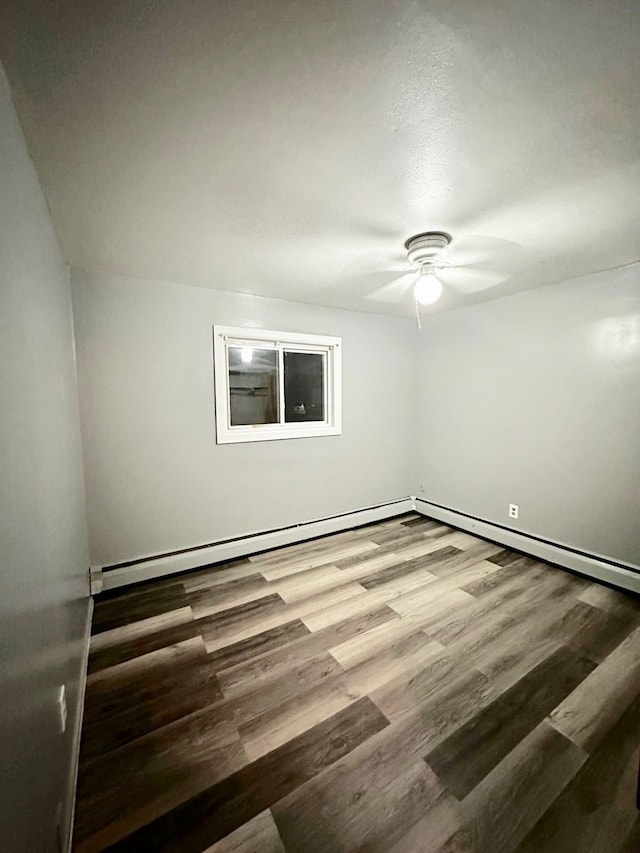 empty room with hardwood / wood-style flooring and ceiling fan