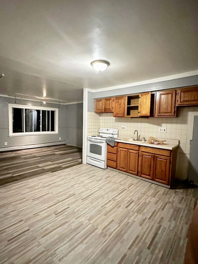 kitchen featuring sink, decorative backsplash, electric range, baseboard heating, and light hardwood / wood-style floors