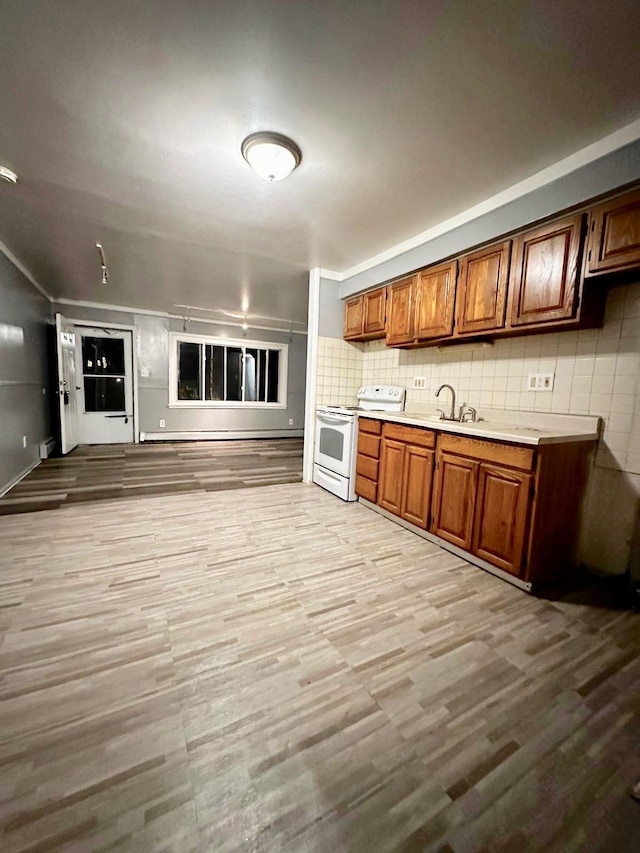 kitchen with tasteful backsplash, sink, light hardwood / wood-style floors, and electric stove