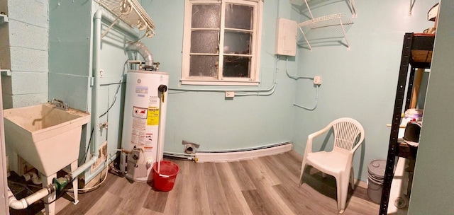 utility room featuring sink and water heater