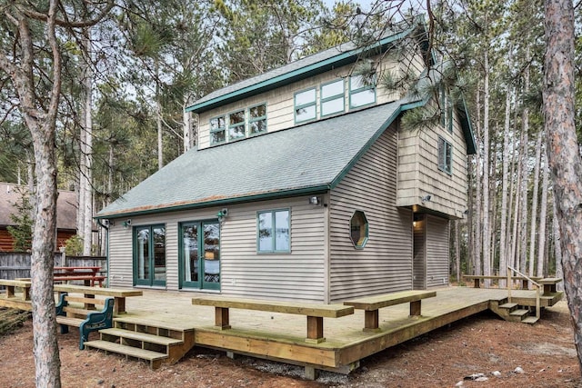 rear view of property featuring a deck