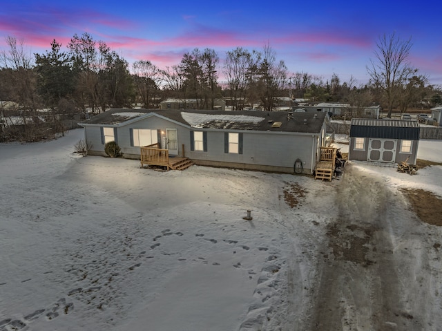 back house at dusk featuring a shed