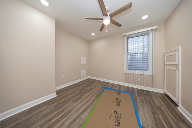 empty room featuring ceiling fan and dark hardwood / wood-style flooring