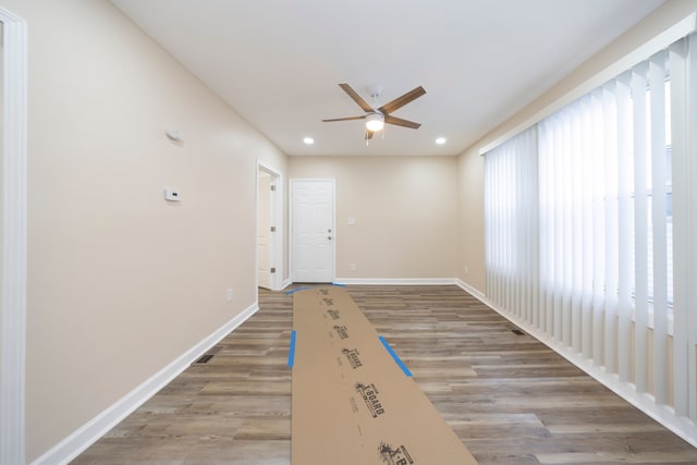 spare room featuring light hardwood / wood-style floors and ceiling fan