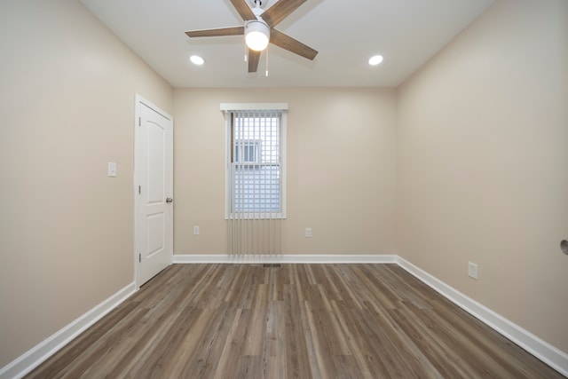 spare room featuring ceiling fan and dark hardwood / wood-style flooring