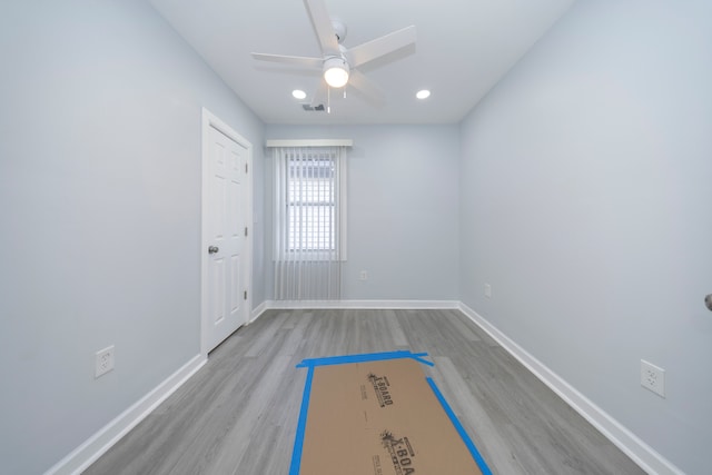 spare room featuring light hardwood / wood-style floors and ceiling fan